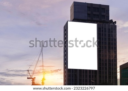 Mock up white background billboard on building, clipping path for Mockup. A large empty billboard on a city background in the middle of the sunset. Royalty-Free Stock Photo #2323226797