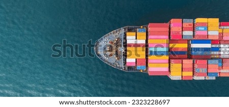Aerial top view Cargo Ship carrying container and running for export goods from cargo yard port to other ocean concept freight shipping ship .