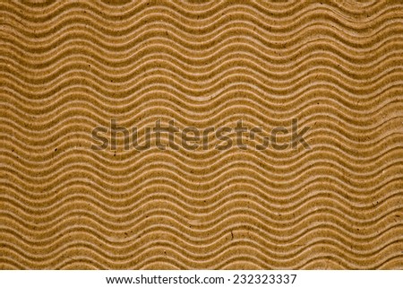 Paperboard texture with wave pattern closeup photo background.