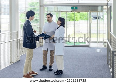 A multinational group having a conversation in the lobby.
People in white coats and sales staff. High angle view. Royalty-Free Stock Photo #2323238735