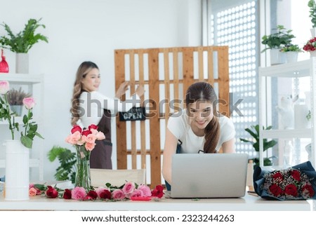 Beautiful asian businesswoman holding signboard with text open in the shop.