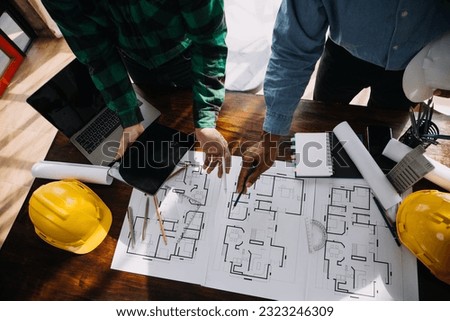 Construction and structure concept of engineer working drawing on blueprint meeting for project working with partner on model building and engineering tools in working site, construction concept.