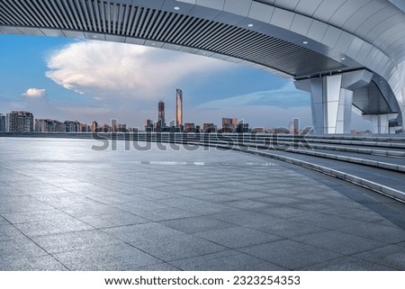 Empty square floor and bridge with city skyline scenery