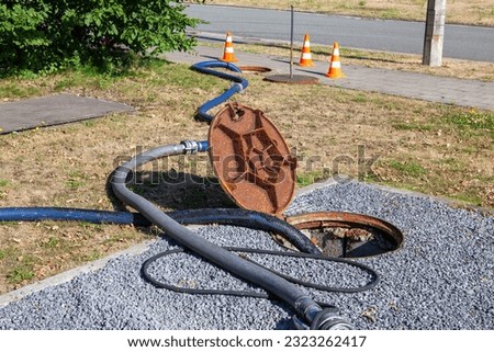 The clearing service is checking the sewer to make sure it is not clogged Royalty-Free Stock Photo #2323262417