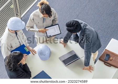 Group of multinational engineers and business people meeting in a building. International business. High angle view. Royalty-Free Stock Photo #2323274589