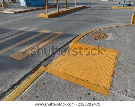 Sidewalk ramp, manhole, road markings