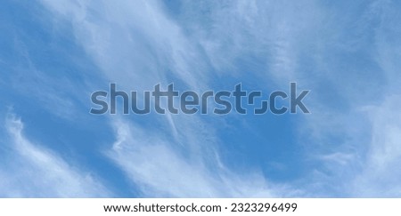 The photo of blue sky and clouds, shot from bottom up to the sky in the sunshine day. The blue sky background texture for decorative and design.