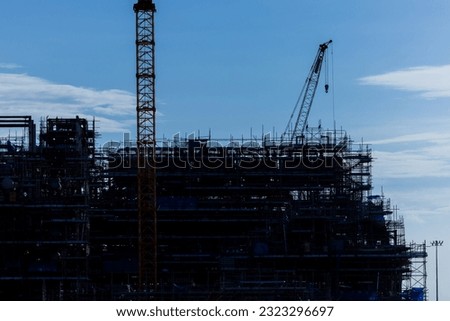 Silhouette, Crane building construction site.Construction site with cranes and building with blue sky background.Large Construction site including cranes working with buildings. beam, steel structure.
