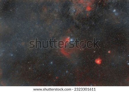 Photo of outer space. soft focus. Lots of small stars all over the frame. foggy objects. Red nebulae in the constellation Cassiopeia.