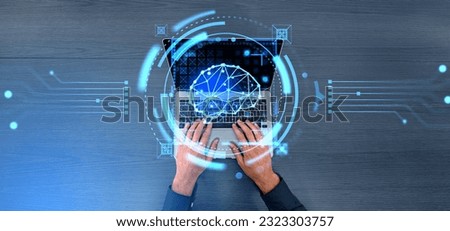Man hands typing on laptop keyboard, top view. Glowing brain hud with connected digital lines and scanning system. Concept of artificial intelligence and technologies Royalty-Free Stock Photo #2323303757