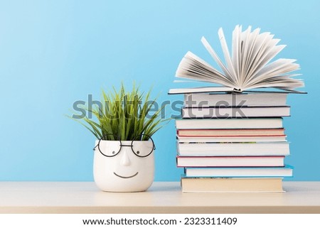Old books on a table, with one book open and copy space for your text Royalty-Free Stock Photo #2323311409