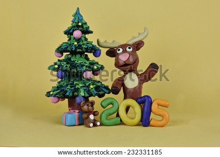 Clay deer with numbers and gifts near the Cristmas tree