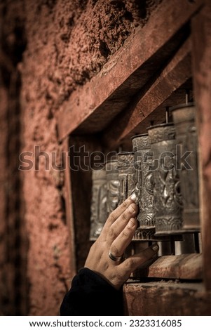 It is a photo of prayer wheel which followers of Lord Buddha use and chant a Mantra. Royalty-Free Stock Photo #2323316085