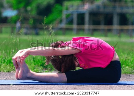 Young sporty beautiful girl stretching on an exercise mat. Joga, sport, healthy lifestyle  concept. 