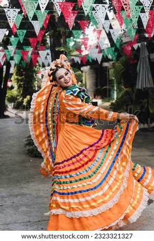 Latin woman dancer wearing traditional Mexican dress traditional from Guadalajara Jalisco Mexico Latin America, young hispanic female in independence day or cinco de mayo parade or cultural Festival Royalty-Free Stock Photo #2323321327