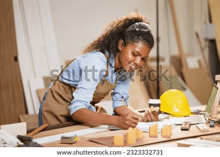 Carpenter Woman Woodworking In Workshop Designer Building Wood Home. Architect Women Smart Work. Happy Joiner Construction Engineer With Design Floor Plan. Royalty-Free Stock Photo #2323332731