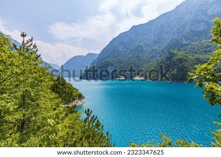 Landscape view of big lake between mountains at summer day. Travel background image with Piva lake in Montenegro