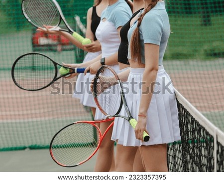 Girls with rackets on the tennis court. Sport.
