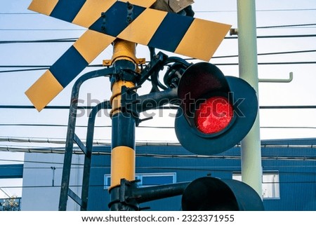 Industrial or transportation background featuring detail of local railway station with contact lines and red traffic signal in Kyoto, Japan.