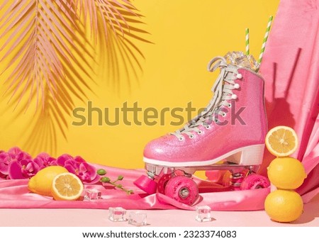 Summer creative layout with pink roller skate with ice cubes, lemons, flowers, pink curtain, pink palm leaf on pastel pink and yellow background. 80s or 90s retro aesthetic Summer refreshment idea.  