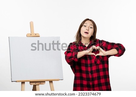 front view young female with easel for drawing on white background draw painting color artist art tassel photo
