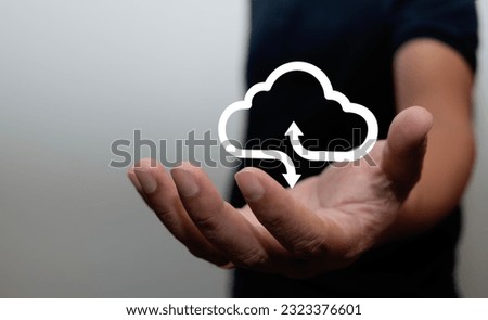 man holding white cloud icon The cloud computing concept connects the smartphone to the cloud. computer network information technologist laptop with smartphone big data concept