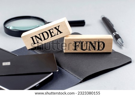 INDEX FUND text on a wooden block on black notebook , business concept