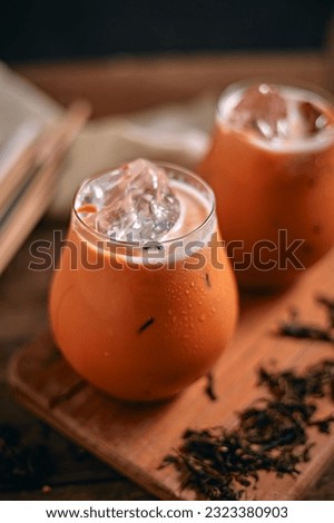 Iced thai milk tea in glass, selective focus