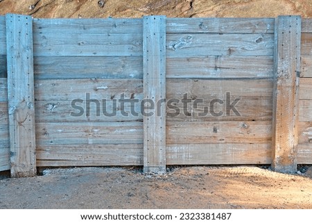 Treated pine sleeper retaining wall Royalty-Free Stock Photo #2323381487
