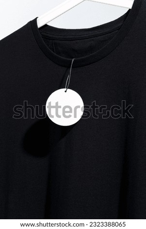 Black t-shirt with blank price tag on hanger