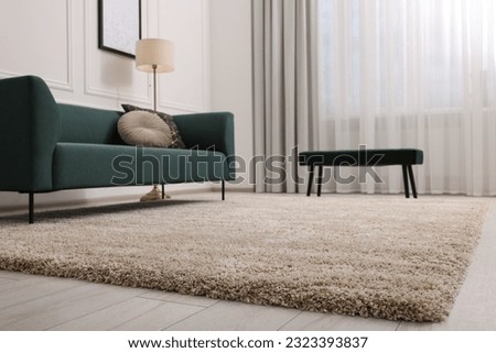 Stylish living room with soft beige carpet and sofa. Interior design Royalty-Free Stock Photo #2323393837