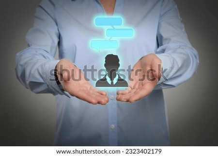 Communication and dialogue concept. Woman holding illustration of faceless man with speech bubbles on grey background, closeup