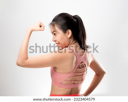Asian woman smiling to the camera, studio light on white background. Healthy and happy woman in exercise outfit cloth