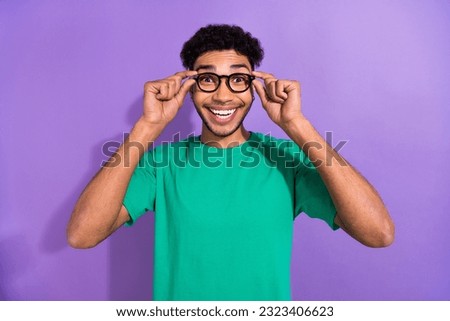 Portrait of astonished cheerful man arms touch eyeglasses toothy smile isolated on purple color background Royalty-Free Stock Photo #2323406623