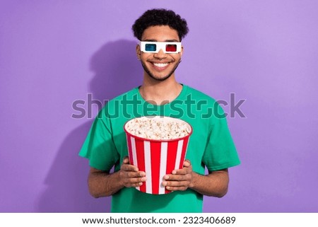 Photo of cheerful handsome man hold popcorn box beaming smile 3d glasses isolated on violet background