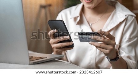 Mobile Shopping. Cheerful Asian Woman Using Smartphone Shopping Online Holding Credit Card Making Payment Sitting At Sofa At Home. Internet Banking Application And E-Commerce Royalty-Free Stock Photo #2323412607