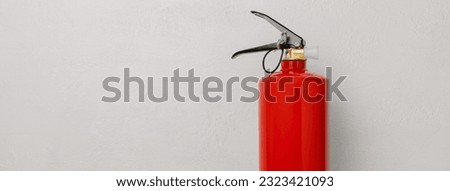 Fire extinguisher on a light texture background. Fire protection, home fire extinguisher. home security concept. Place for text. Copy space.banner