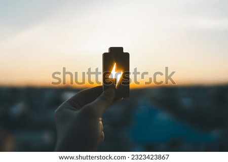 Technology battery high power electric energy with a connected charging cable. Battery to electric cars and mobile devices with clean electric, Green renewable energy battery storage future. Royalty-Free Stock Photo #2323423867