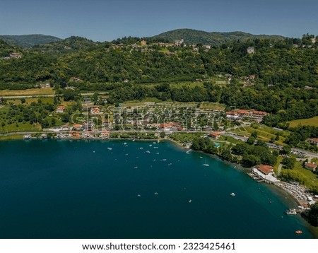 Beautiful drone view of the mountains surrounding Lake Orta in Italy. The beauty of the nature of the Piedmont region. Romantic lake in Italy. 