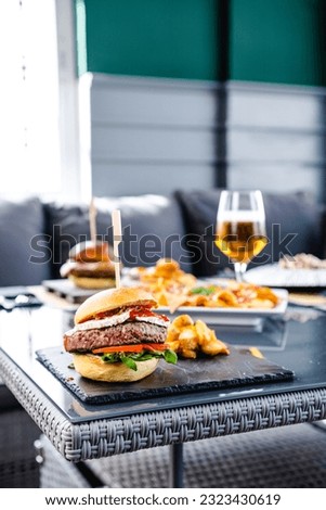 Delicious burger with potatoes and beer