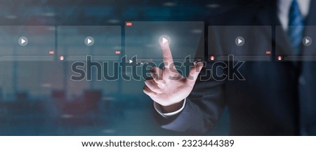 Online business, live video streaming concept. Businessman making video of business 4.0. Man using hand for online stream on virtual screen, watching on internet, live, show, podcast, online content. Royalty-Free Stock Photo #2323444389