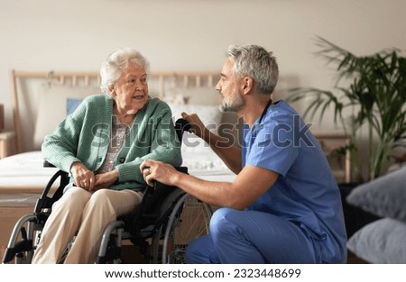 Caregiver doing regular check-up of senior woman in her home. Royalty-Free Stock Photo #2323448699