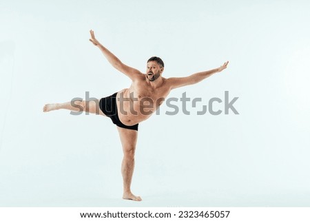 Man posing for a male edition body positive beauty set. Shirtless guy wearing boxers underwear in studio Royalty-Free Stock Photo #2323465057