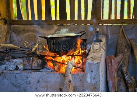 Authentic and traditional way of cooking the creole food in Seychelles, on  cast iron pot in direct wooden flames, Mahe Seychelles. Royalty-Free Stock Photo #2323475643