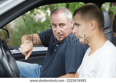 two men arguing after a car accident Royalty-Free Stock Photo #2323476983