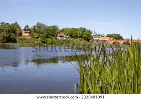Latvia landscape photography of Venta river waters and historical red brick bridge of Kuldiga town Royalty-Free Stock Photo #2323481091