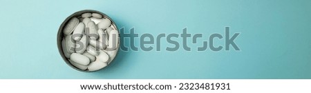 Pills in a box on a blue background, horizontal banner
