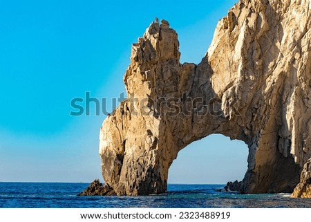 The famous arch of Cabo San Lucas in the Gulf of California that joins the sea of cuts with the Pacific Ocean at the end of the earth, in Baja California Sur. Mexico beach concept.