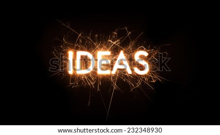 The word Ideas set in sparklers on black background with copy space. Royalty-Free Stock Photo #232348930