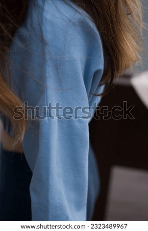 View of aestetic body of a girl in blue gym suit in cloudy weather in the park
